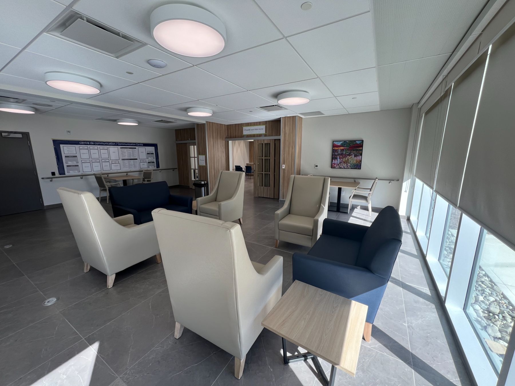 Foyer Richelieu lobby lounge with cream and navy wingback chairs beside the communication centre and chapel