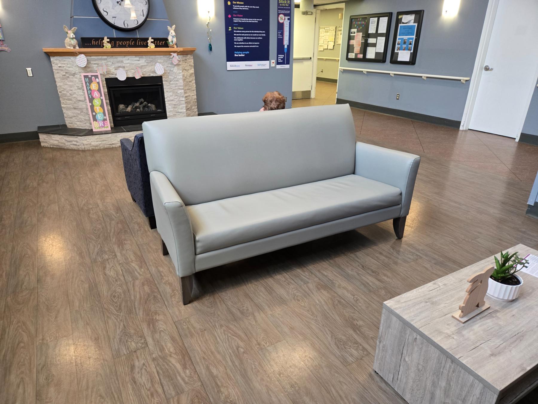 Care-home lobby furnished with an IntelliCare lounge settee beside the fireplace